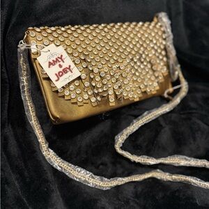 Luxurious Gold Wristlet with Shimmering Texture and Chain Strap